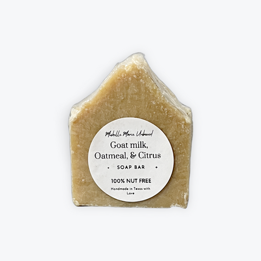 Goat milk, oatmeal, and citrus soap bar with a label on a white background