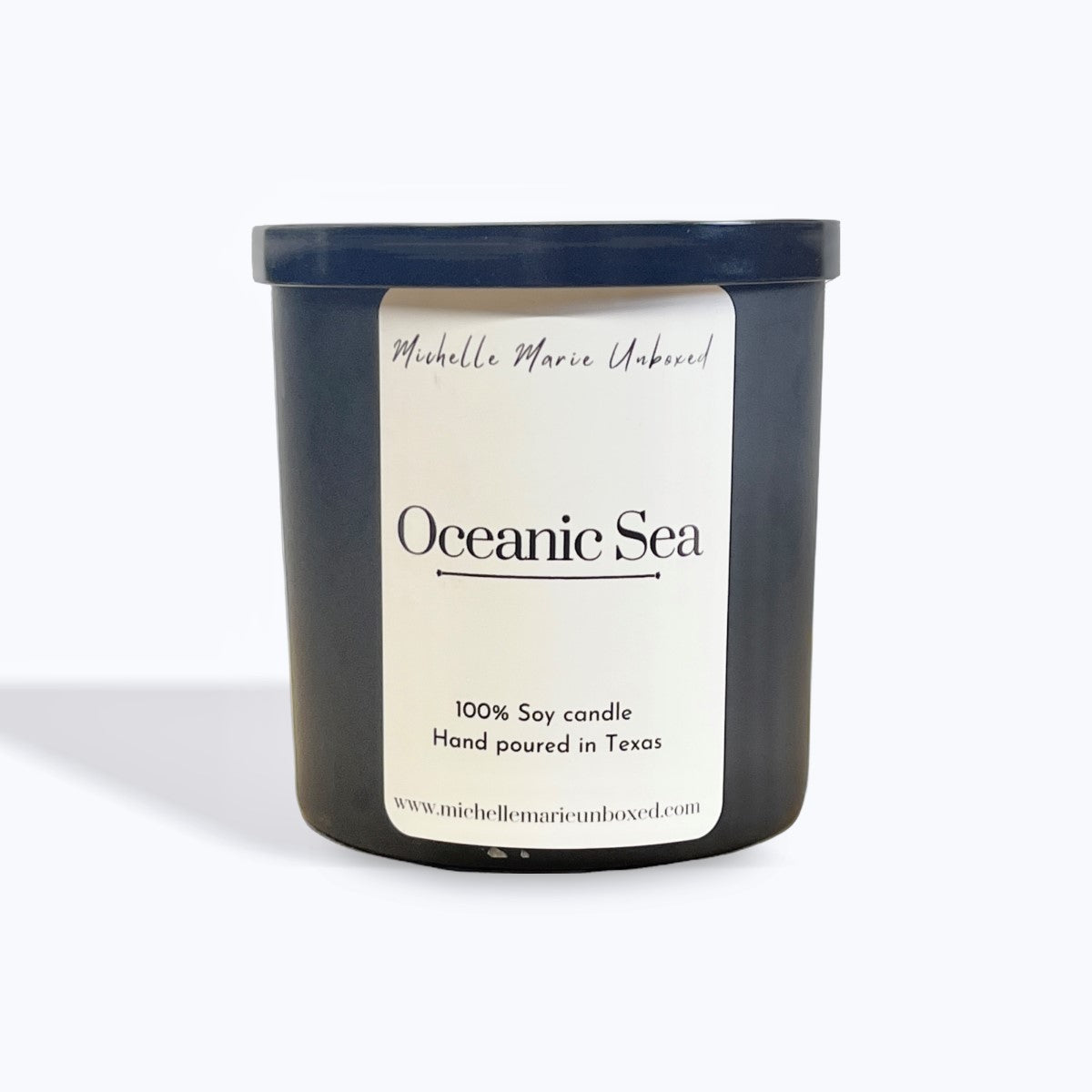 Candle jar labeled 'Oceanic Sea' by Michelle Marie Unboyed on a white background
