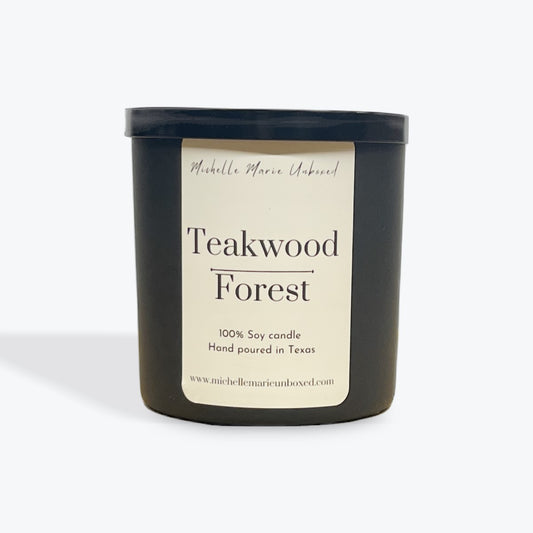 Black candle jar with 'Teakwood Forest' label on a white background